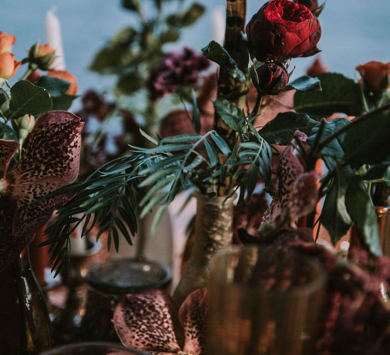 Dried foliage, roses and orchids for beachside table centrepieces