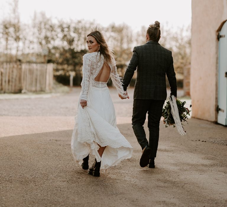 Bride in open back lace fringe sleeve wedding dress