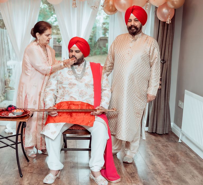 Groom is fed before wedding ceremony 