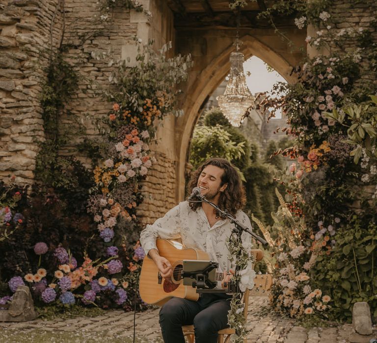 Musician playing his guitar and singing at an outdoor wedding at Euridge Manor 