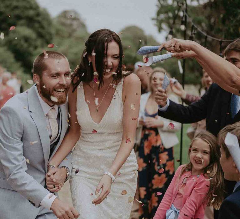 Confetti moment for bride and groom at Pylewell Park wedding