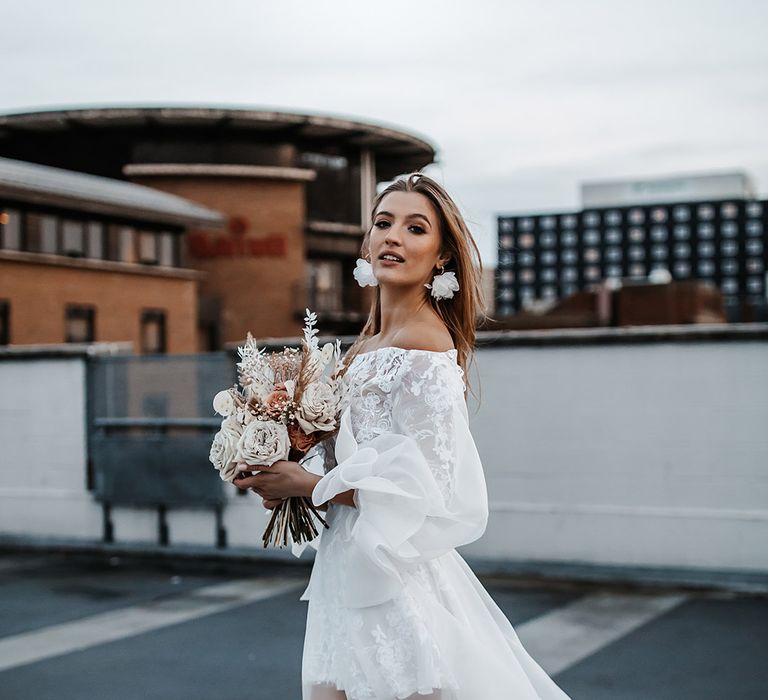 Bride in a Daniel Chu wedding dress holding a dried flower bouquet 