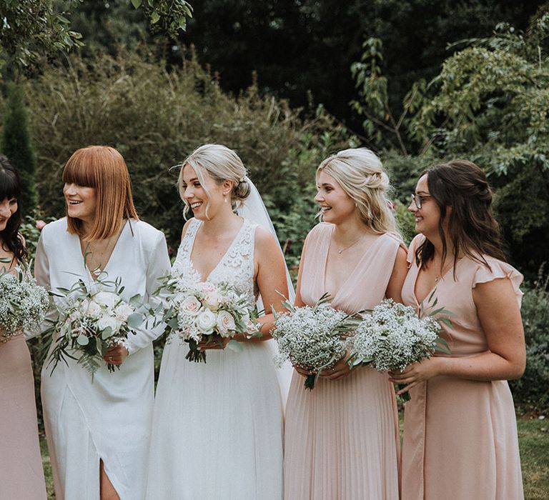 Beautiful pink bridesmaid dresses with white gypsophila bouquets