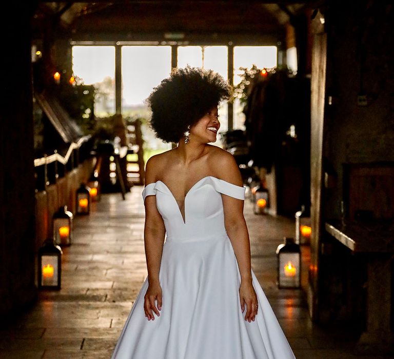 Black bride wears her afro hair naturally and off the shoulder wedding gown