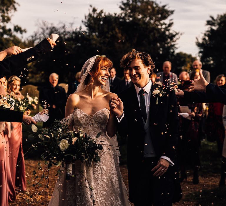 Martini Liana wedding dress for bride during confetti moment with groom