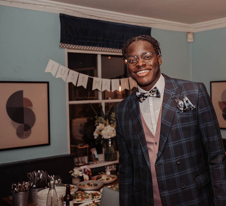 Groomsmen wears tartan suit on wedding day