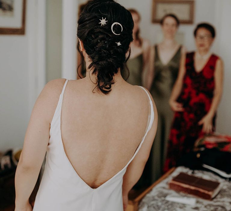 Bride wears her dark hair pulled back into stylish up-do featuring silver hair accessories  | Irene Yap Photography