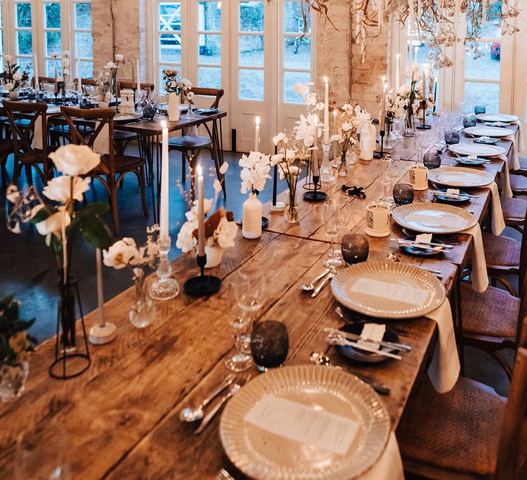 Monochrome and neutral wedding table decor with fresh and dried flowers, taper candles and ornate tableware