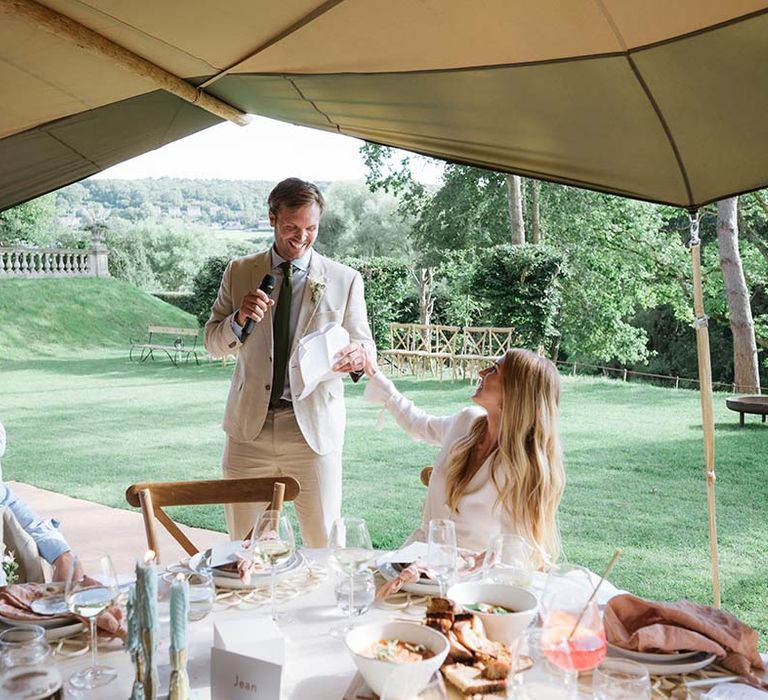 Groom gives a speech at his garden wedding in Buffalo Tipi