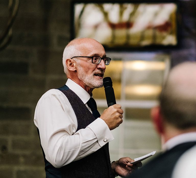 Father of the bride gives a speech at country house wedding in fabric waistcoat 