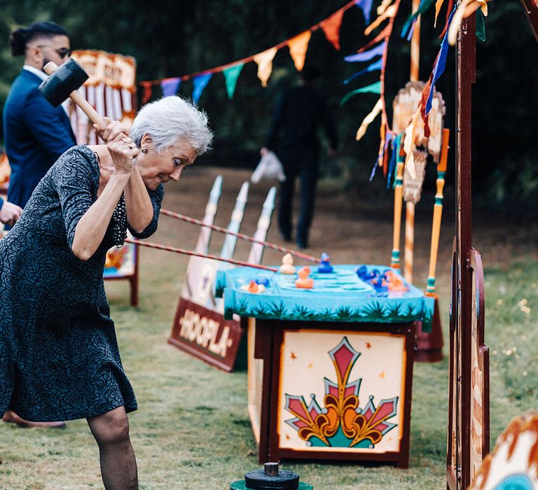 Wedding guest competes in fairground games at wedding