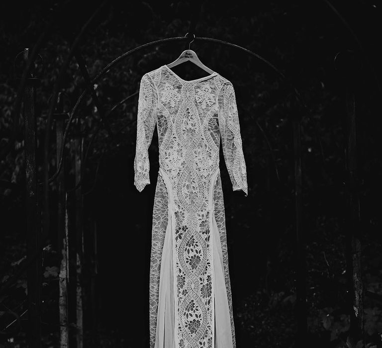 Boho lace wedding dress and train on a hanger 