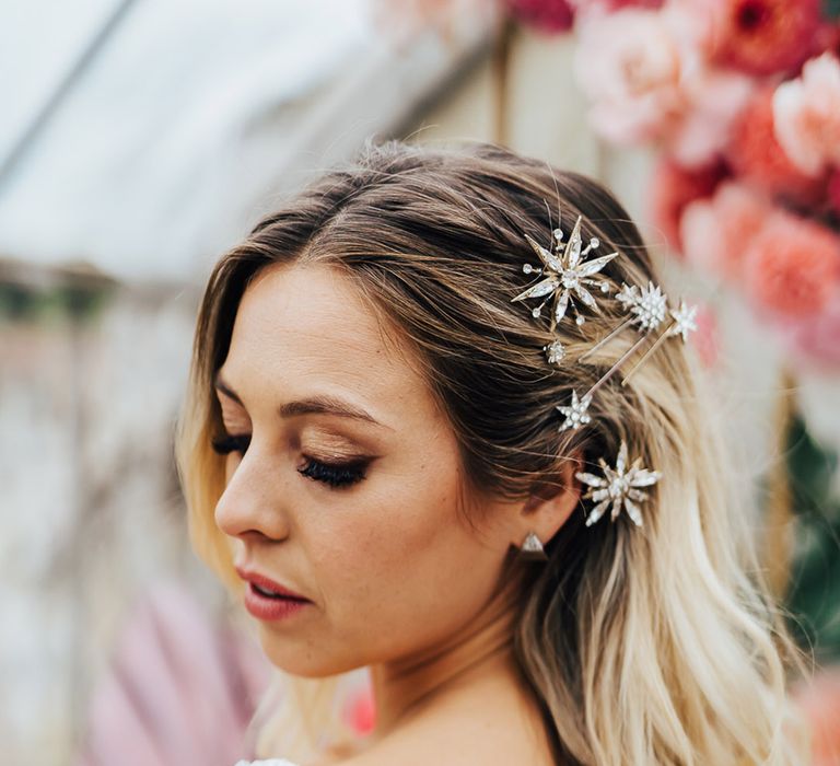 Bride with her blonde hair pinned to the side with a sparkly celestial style hair accessories 