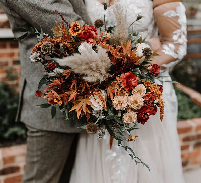 Close up of the bridal bouquet with orange and red wedding flowers 