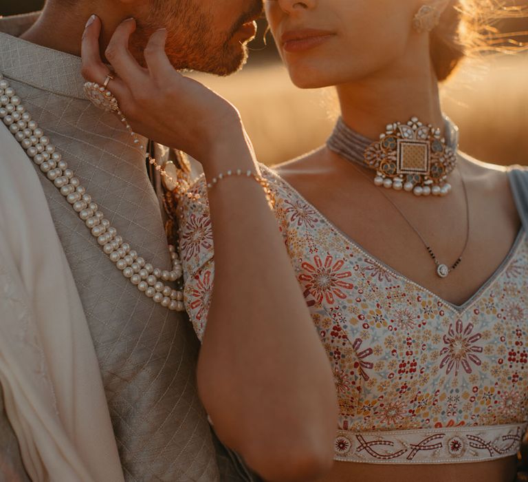 Bride & groom embrace outdoors in fields during golden hour at Billinghurst Hill Farm