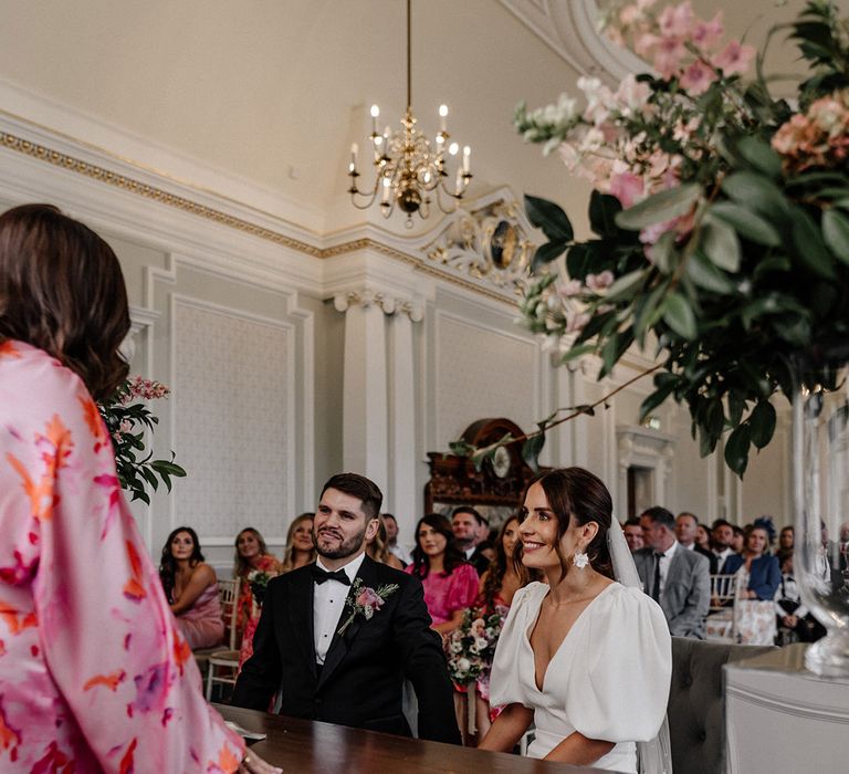 Bride and groom at stylish modern wedding signing the register