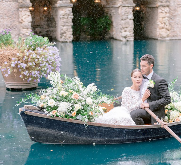 The bride and groom share a romantic moment together on a row boat for their Italian inspired wedding 