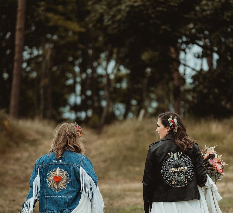 Bride in customised embroidered denim jacket and bride in personalised embroidered leather jacket with musical theme 