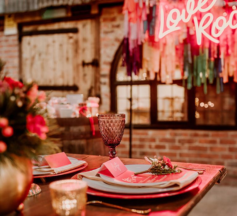 Hot pink and fuchsia retro wedding stationery with gold plates, pink plates and gold cutlery 