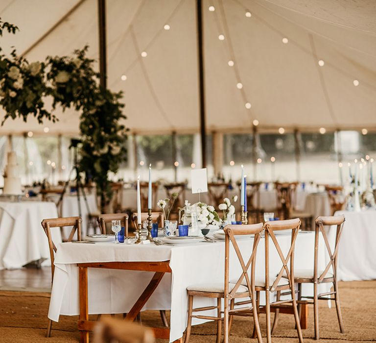 Marquee wedding at Hinwick House with festoon lighting and blue and white wedding decor colour scheme 