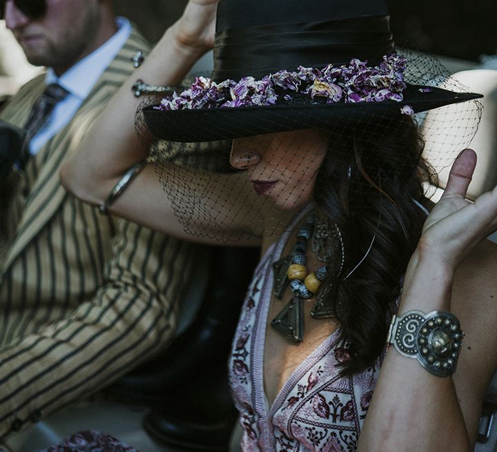 Black boho wedding hat with black netting and dried pink and purple flowers