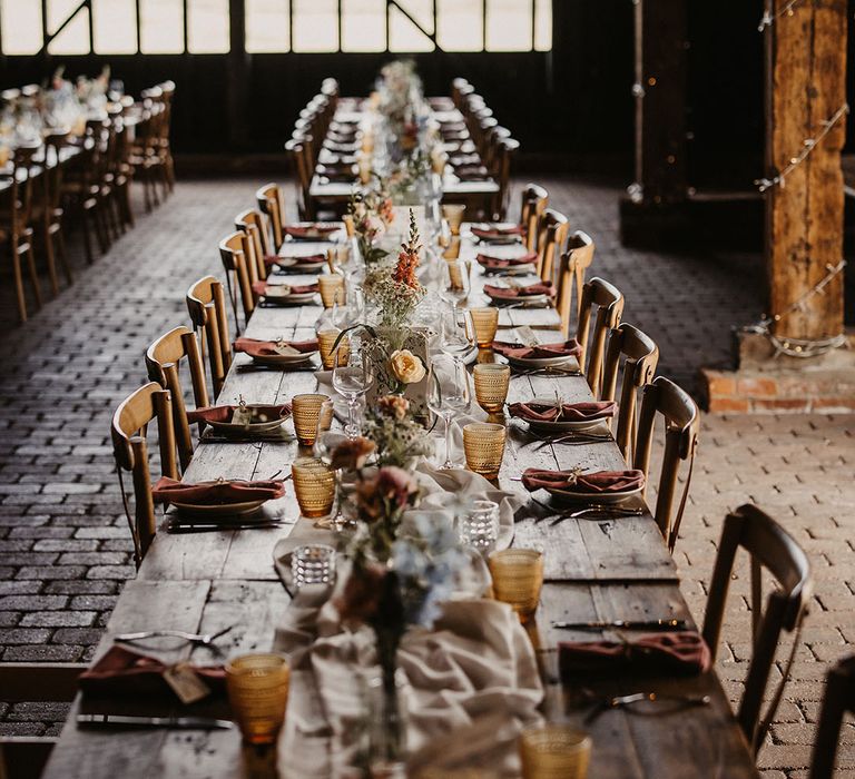 Elmley Nature Reserve wedding venue in Kent with long tables decorated with pastel flowers and glassware 