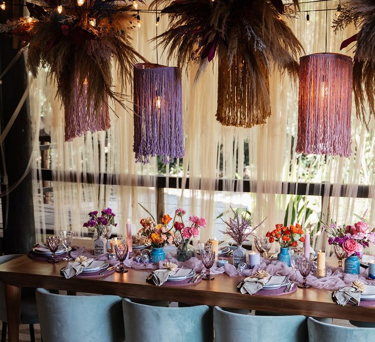 Tropical tablescape for Brazil destination wedding with pampas grass and festoon lighting 