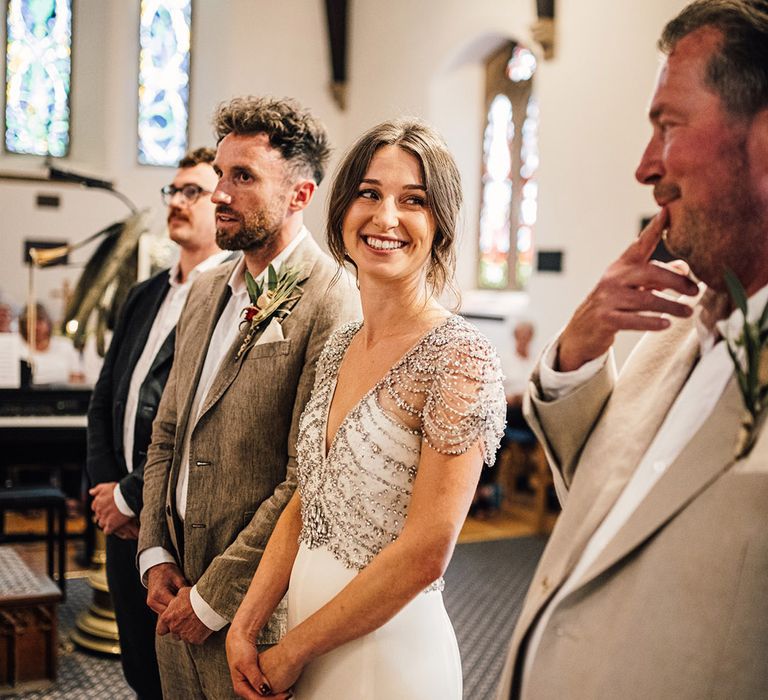 Father of the bride, bride and groom stand at the altar for the traditional church wedding ceremony 