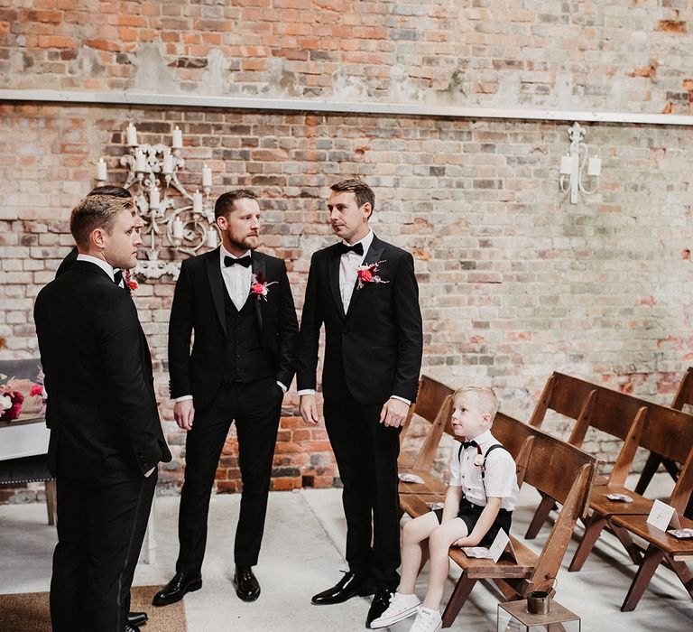 Groom and groomsmen in black tuxedos with little boy ring bearer at The Barn at Botley Hill wedding 