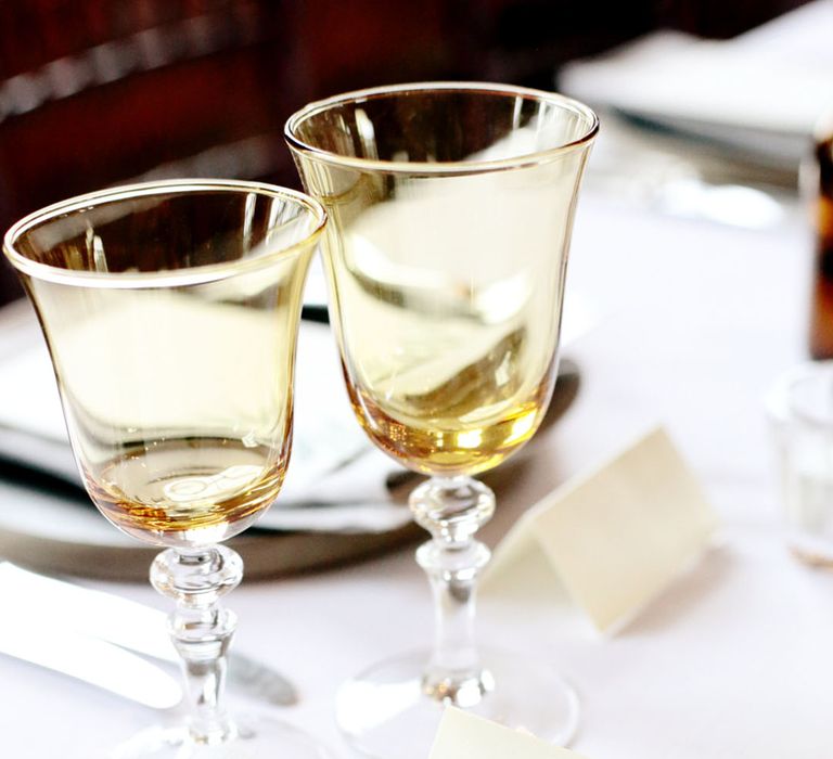 Yellow coloured glassware with simple wedding place name sign 