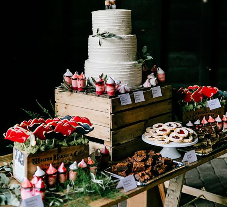 Dessert table spread for wedding guests food and drink options, including wedding cake