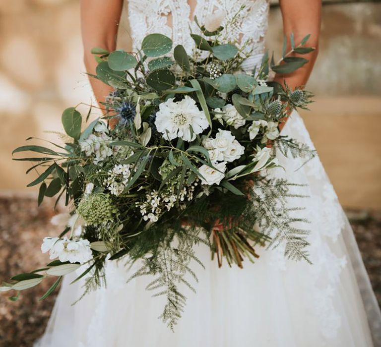 Green wedding theme ideas with heavy foliage wedding bouquet with white flowers for luxury traditional wedding 