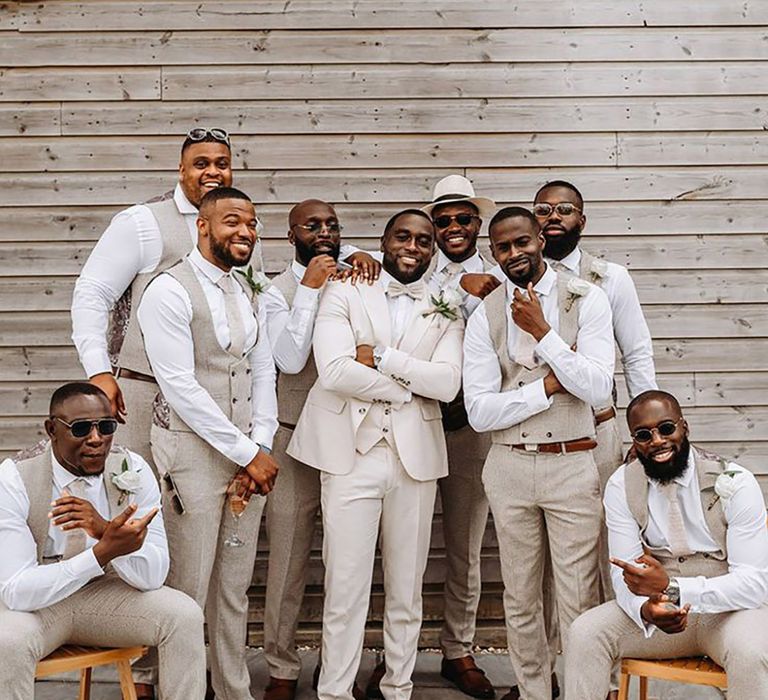 Groom and groomsmen in cream wedding suits for boho luxe wedding with a neutral colour scheme 