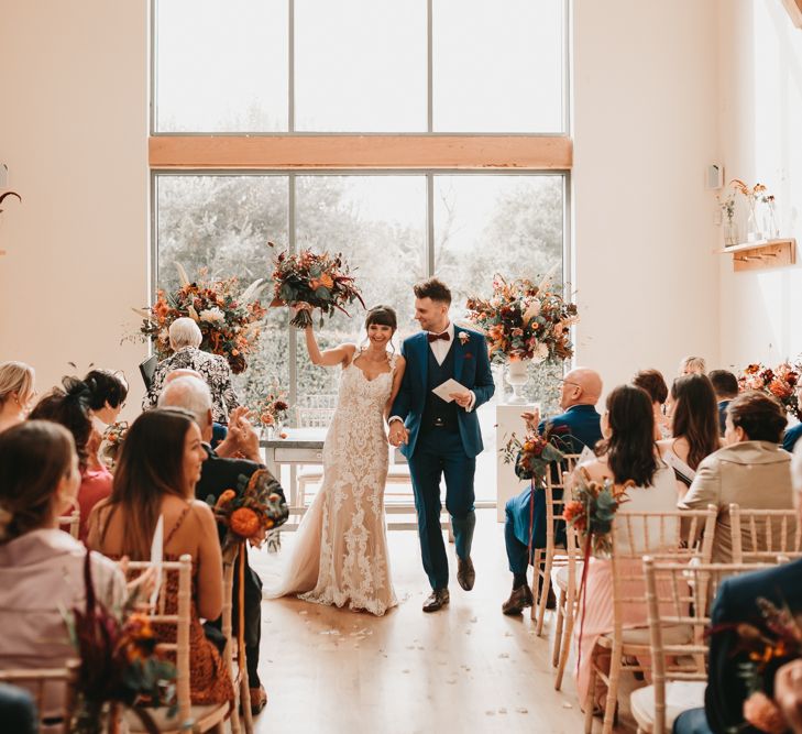 Bride and groom just married at Millbridge Court wedding with Autumn wedding flowers