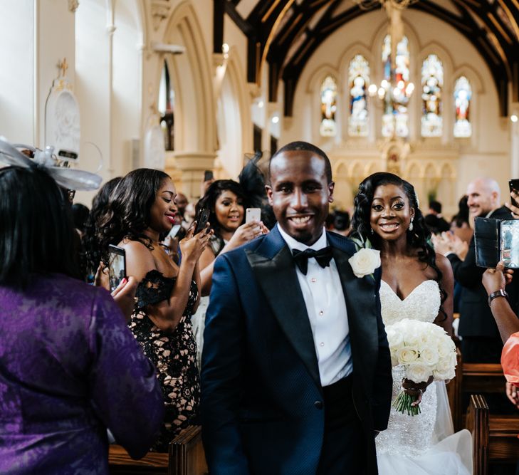 Bride and groom exiting their catholic wedding ceremony 