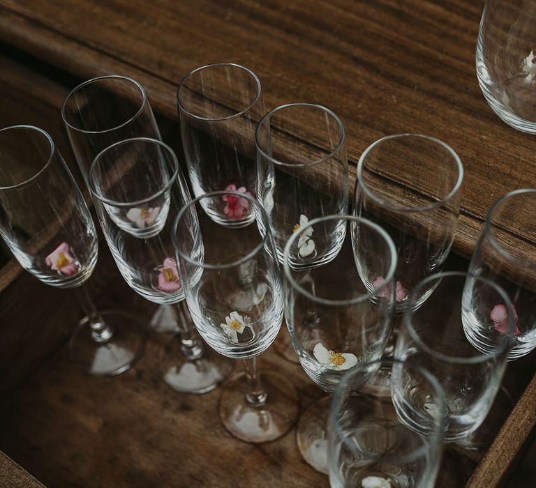 Champagne glasses decorated with edible flowers 