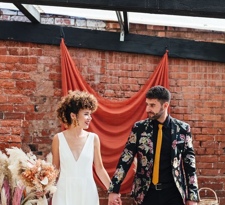 Groom in black trousers and patterned blazer 