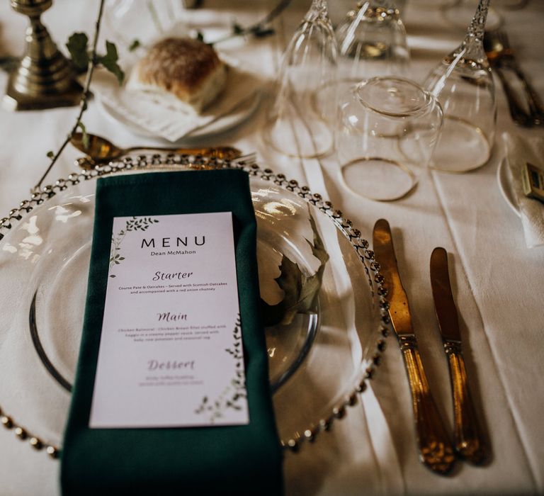 Rustic menu and gold tableware at boho wedding in the highlands