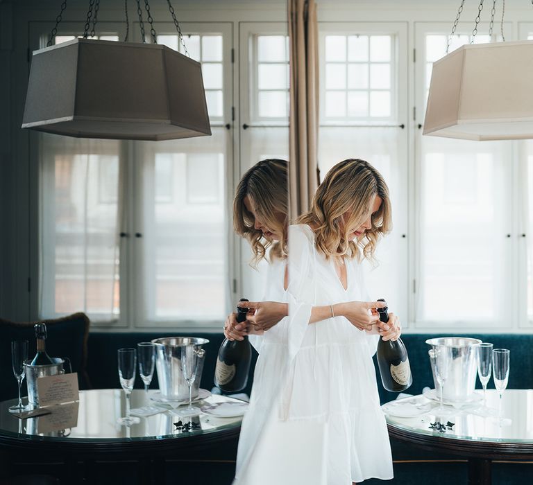 Bride on the morning of her wedding opening champagne