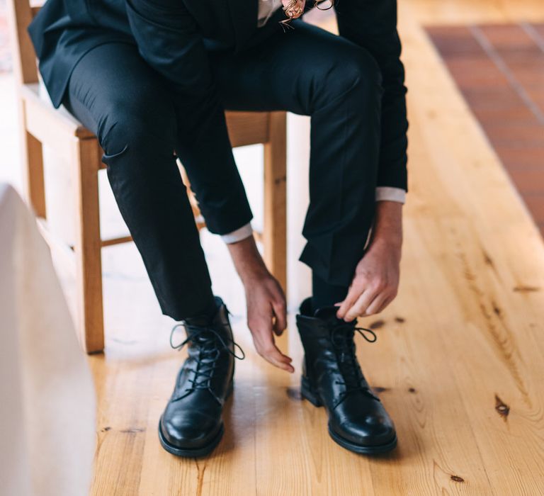 The groom getting ready in a relative's coastal summer house for destination wedding in Sweden