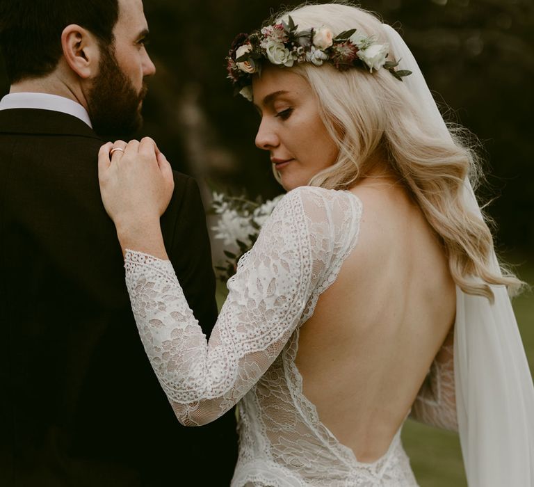 Bride in backless Grace Loves Lace wedding dress and single tier cathedral length veil stands with groom in black Hugo Boss suit at Drenagh Estate Wedding