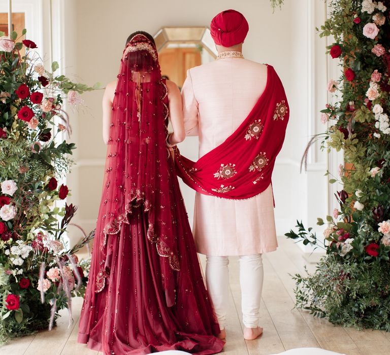 Bride & groom stand with their backs to the camera