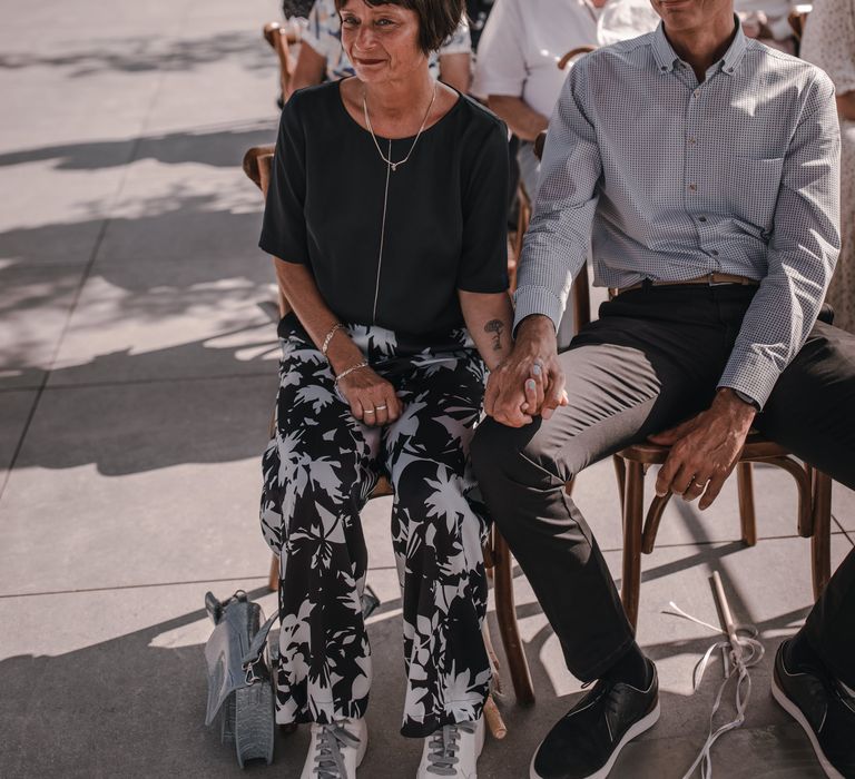 Wedding guests watch ceremony at rooftop venue