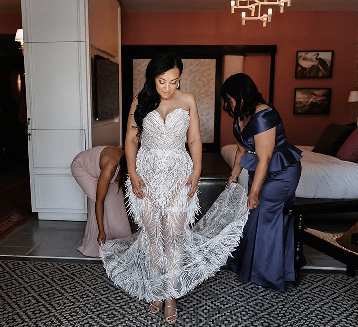 Bride in a strapless Biji La Maison de Couture wedding dress on her wedding morning having her dress fanned out