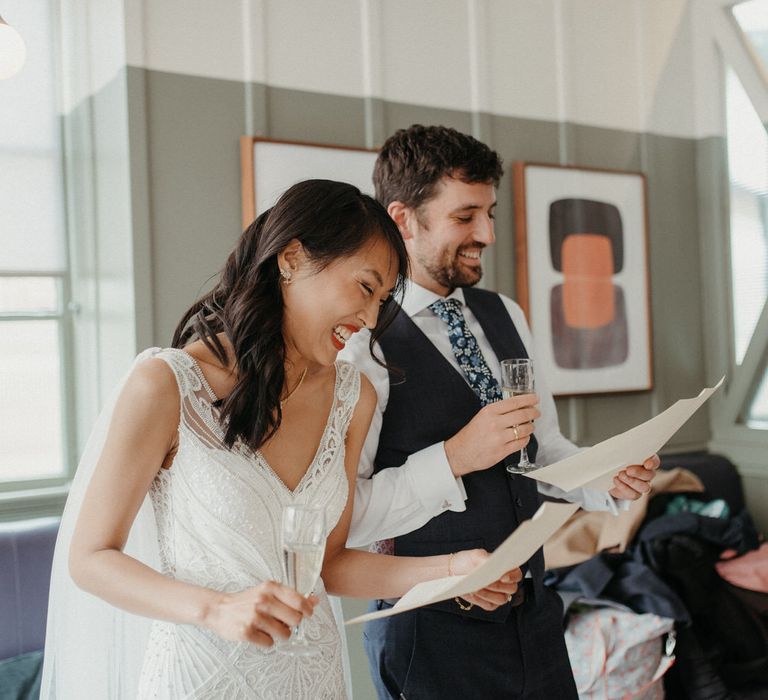 The bride and groom laughing as they both make speeches