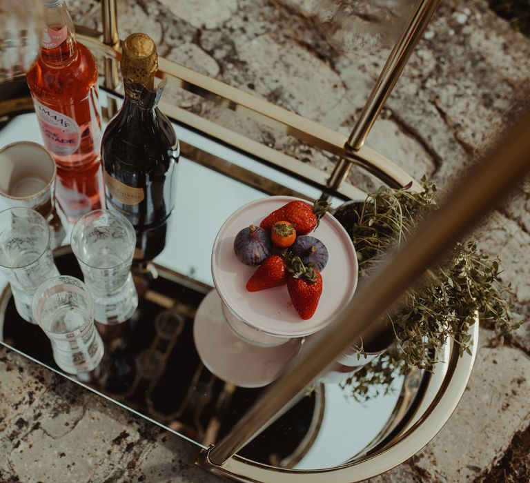 Cocktails on gold drinks trolley at boho wedding inspiration at Almonry Barn Somerset