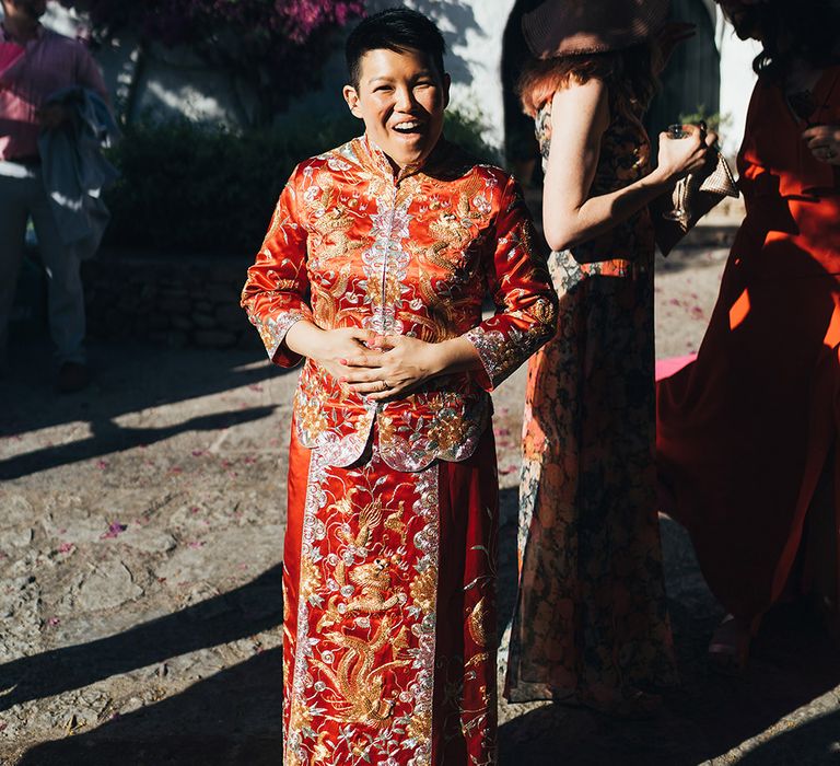 Bride smiles during traditional Chinese tea ceremony in Menorca