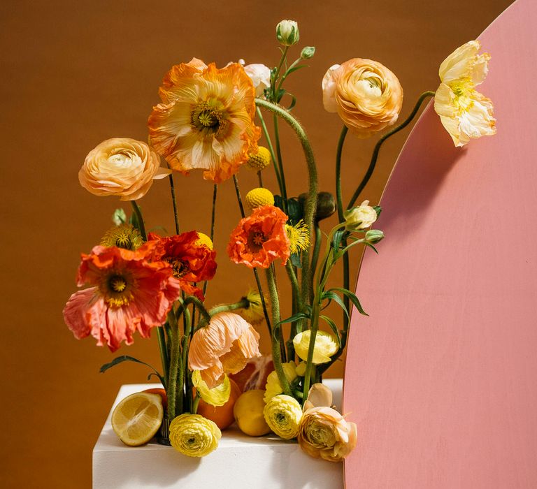 Orange and peach poppy wedding floral installation by Boom Blooms with citrus fruit details