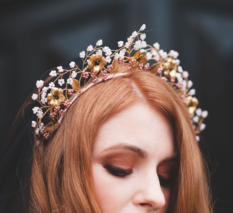 Bride with long auburn hair in a wire headdress with brown eyeshadow and coral lipstick