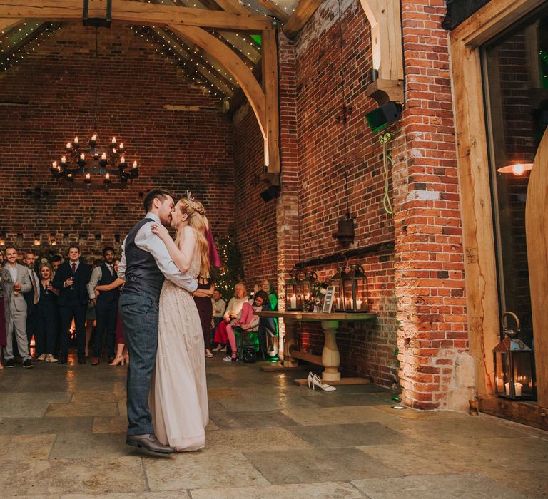 Bride and groom kissing on the dance floor at their rustic Hazel Gap Barn wedding 